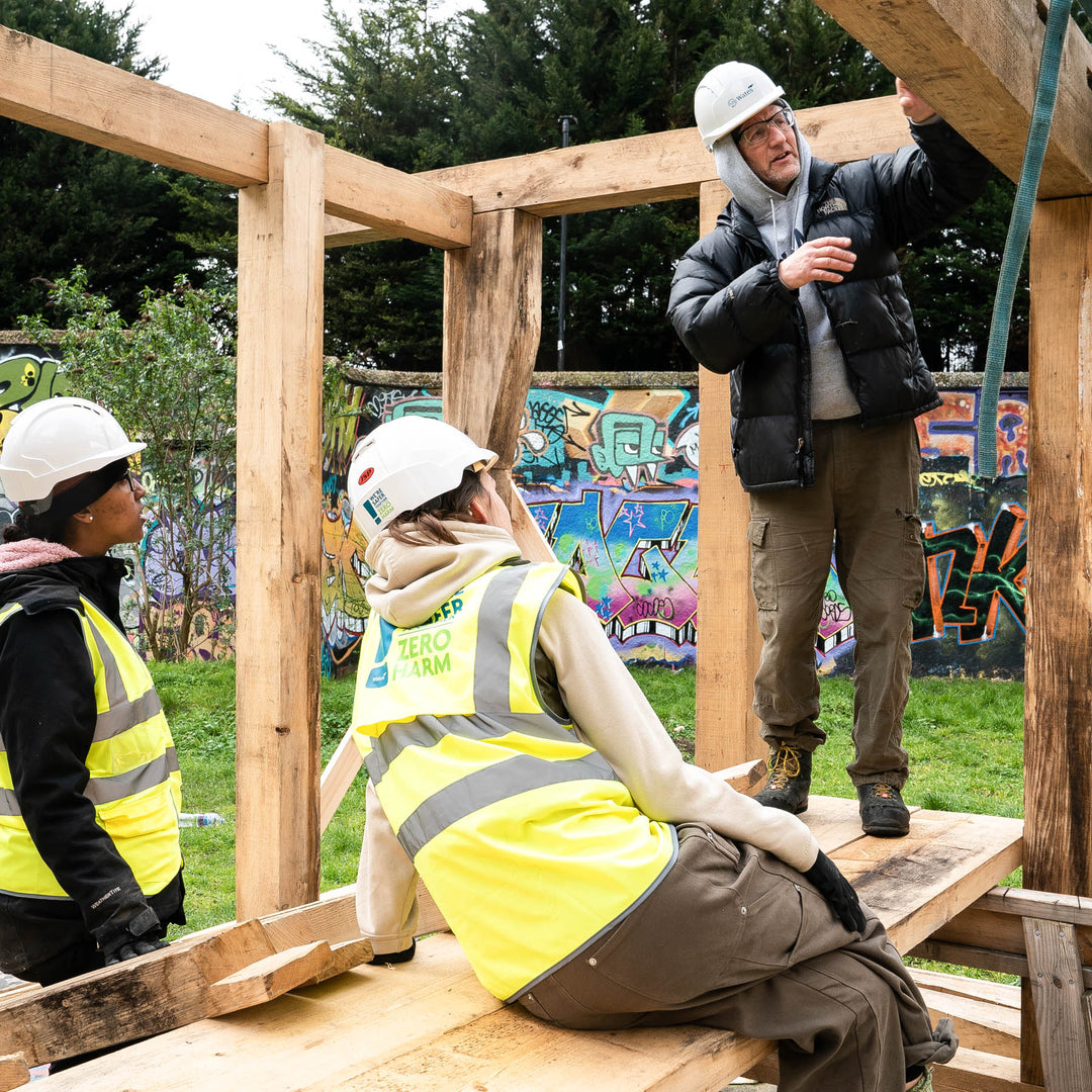 Goldfinger trainees learning to build a timber-frame house