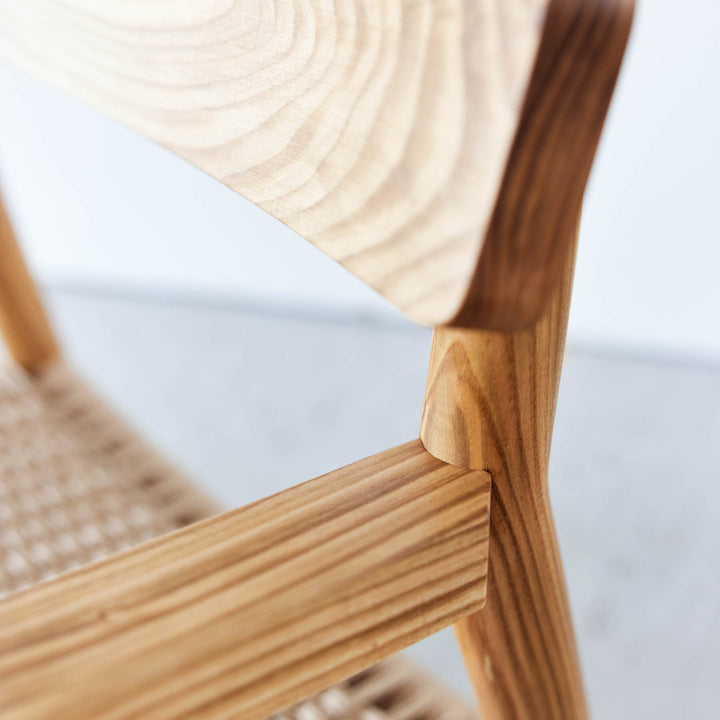 Detail view of the Goldfinger Vale lounge chair made from sustainable cherry, handcrafted